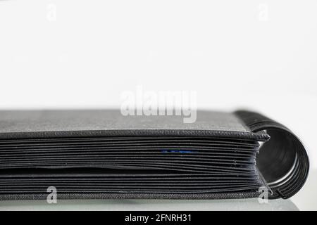 Side view of a black ring binder of a photo book isolated on white. Space for text above the book Stock Photo