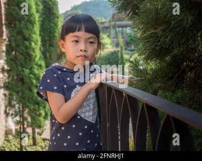 Portrait of a cute Asian small girl posing. Emotional image with space for text. Stock Photo