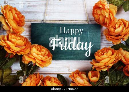 Happy Friday typography text with flower decoration on wooden background Stock Photo