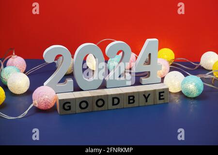 Goodbye 2024 word alphabet letters on red and blue background Stock Photo