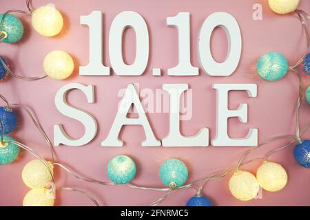 10.10 Sale alphabet letter with LED cotton balls on pink background Stock Photo