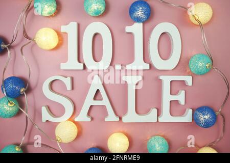 10.10 Sale alphabet letter with LED cotton balls on pink background Stock Photo