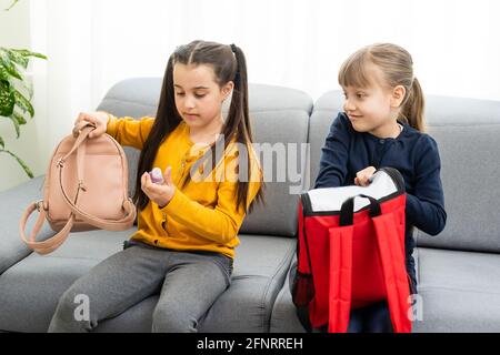 Children go back to school. Start of new school year after summer vacation. girls with backpack and books on first school day. Beginning of class Stock Photo