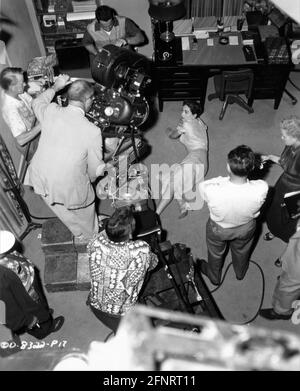 JOAN CRAWFORD candid with Movie Crew during filming of AUTUMN LEAVES 1956 director ROBERT ALDRICH costume design Jean Louis William Goetz Productions / Columbia Pictures Stock Photo