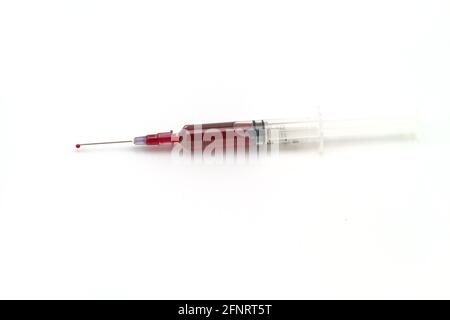 Syringe with blood on white background Stock Photo