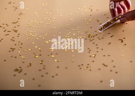 Golden sparkles stars on gold holiday background. Festive backdrop for your projects Stock Photo