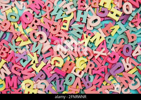 random colorful letterpress alphabet top view on purple background Stock Photo