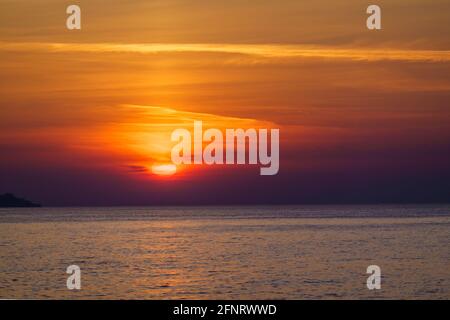Scenic sunset over calm sea Stock Photo