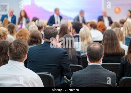 Anonymous people listening to presentation during conference Stock Photo