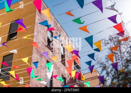 Spanish Catholic Holiday Party Decorations With Colored Flags In Barcelona, Spain Stock Photo