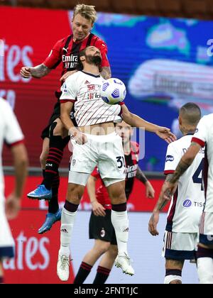 MILAN, ITALY - MAY 16: Simon Kjaer of AC Milan competes for the headed ball with Leonardo Pavoletti of Cagliari Calcio during the Serie A match betwee Stock Photo