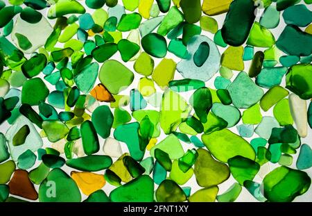 Summer background from sea glass top view. Broken glass from the ocean. Sea pattern. Oceanic mosaic. Natural colors of blue, green, white found on the Stock Photo