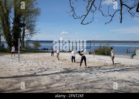 Group of young people playing beach volleyball on the shore of Lake Ammer,Ammersee, Upper Bavaria, Germany,Europe. Stock Photo