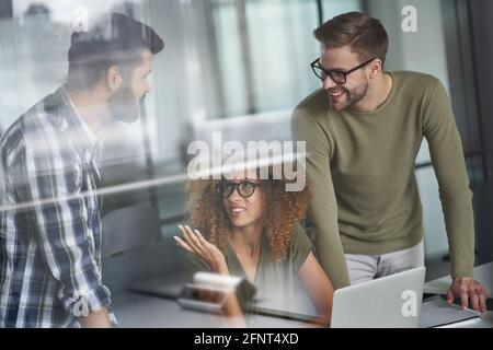 Group of successful multicultural business people or colleagues working together in the modern office, discussing new project or sharing ideas Stock Photo