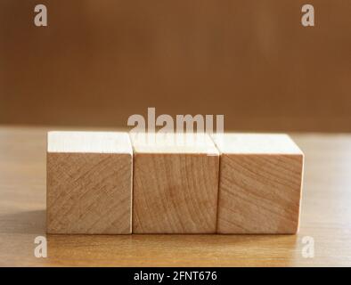 3 Wood Blocks Front View, On Wooden Table, polished wooden table background Stock Photo