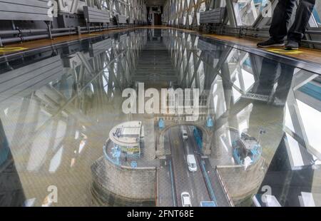 Tower Bridge, London, UK. 17 May 2021. Tower Bridge welcomes people back from today following lifting of government restrictions as the first public visitors arrive to stretch their legs on the high-level walkway with views through the glass floor 42m above the river Thames. Credit: Malcolm Park/Alamy Stock Photo
