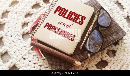 Policies and Procedures text on notebook ,pencil and glasses. Law concept Stock Photo