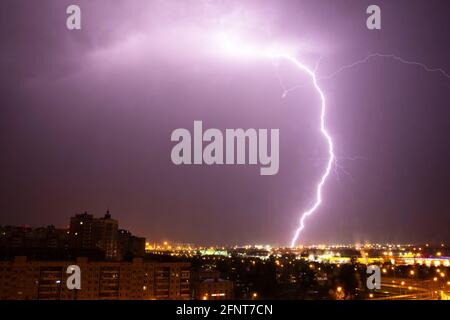 Lightning strike the ground in the city at night Stock Photo