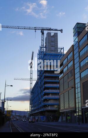 DUBLIN, IRELAND - Oct 27, 2019: Vertical shot of a building construction of the EXO the tallest office building in Dublin, Ireland. Street view at the Stock Photo