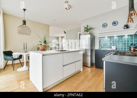 Light kitchen with minimalist style furniture and decorations at daytime in modern flat Stock Photo