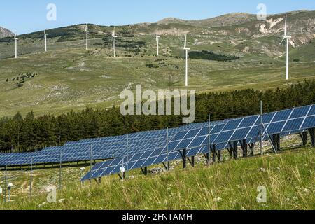 Solar panels and wind turbines for the production of renewable and low-polluting energy. Collarmele, province of L'Aquila, Abruzzo, Italy, Europe Stock Photo