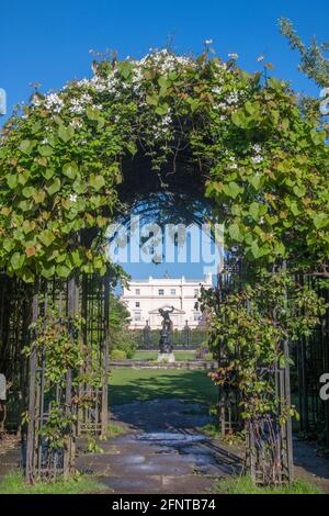 Lodge Gardens and Lodge House seen through ornamental arch Regents Park London Stock Photo