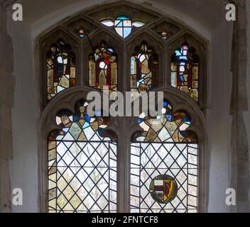 Fragments of medieval stained glass in church window, Wyverstone, Suffolk, England, UK Stock Photo