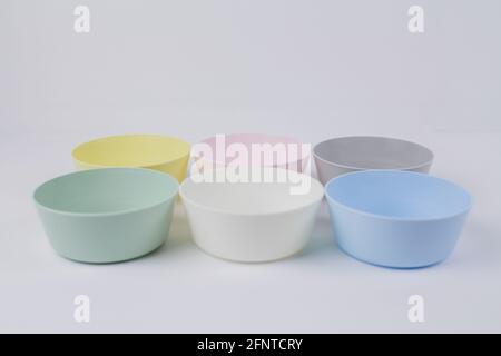 a multicolored plastic plates on a white background Stock Photo