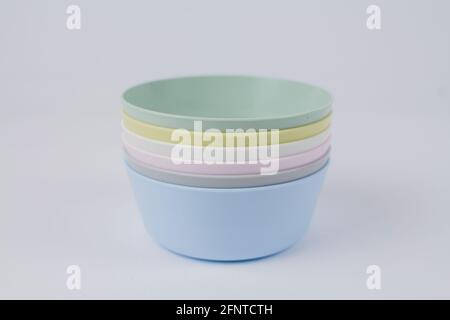 a multicolored plastic plates on a white background Stock Photo