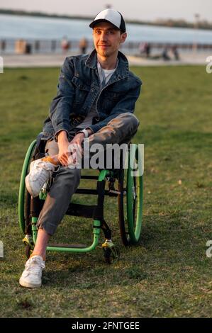 Close up. Disabled Man on Wheelchair outdoor. Disabled Young Man. Man on Wheelchair. Recovery and Healthcare Concepts Stock Photo