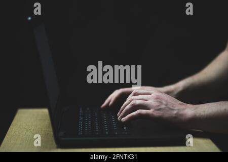 Man type on laptop keyboard. Close up shot of hands and keyboard Stock Photo