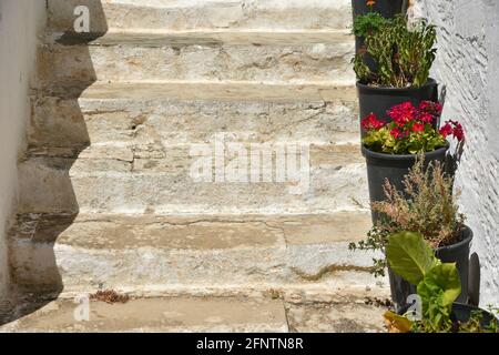 Old rural  house weathered whitewashed stone steps with flower pots in Chora, the capital of Kythira island in Attica Greece. Stock Photo