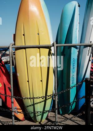 Surfboards and canoes available for hire near Lyme Regis Beach, Lyme Regis, Dorset, United Kingdom, 2019. Stock Photo