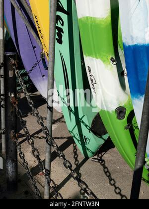 Surfboards and canoes available for hire near Lyme Regis Beach, Lyme Regis, Dorset, United Kingdom, 2019. Stock Photo