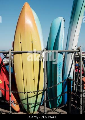 Surfboards and canoes available for hire near Lyme Regis Beach, Lyme Regis, Dorset, United Kingdom, 2019. Stock Photo