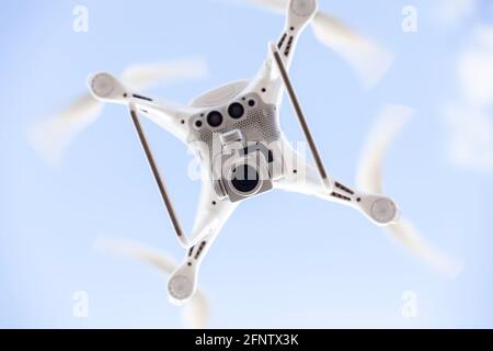 Unmanned modern drone, wide application of drones.-Recording of hard-to-reach places, transport of small things, reconnaissance of the terrain. Stock Photo