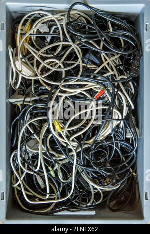 miraculously, the computer and electro cables always intertwine with each other in the cable box Stock Photo