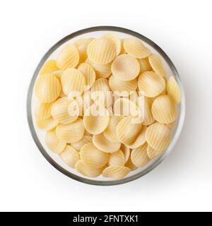 Uncooked orecchiette pasta in glass bowl isolated on white background with clipping path Stock Photo