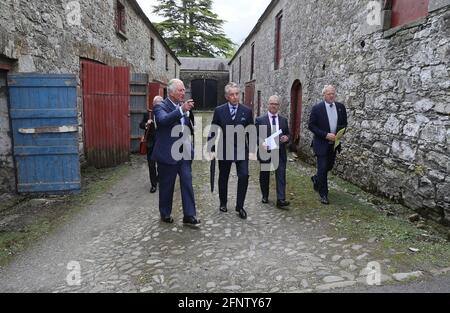 The Prince of Wales (left) with Lord Caledon (centre) during his visit to Caledon where he viewed the sites of upcoming development projects around the village. Picture date: Wednesday May 19, 2021. Stock Photo