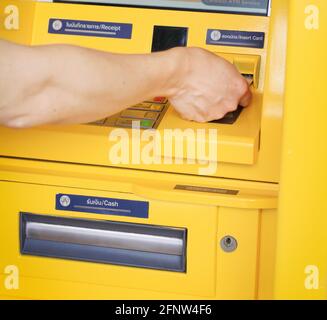 Man pressing password number on ATM machine Stock Photo