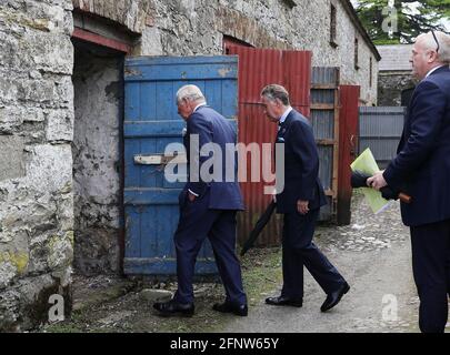 The Prince of Wales with Lord Caledon (second left) during his visit to Caledon where he viewed the sites of upcoming development projects around the village. Picture date: Wednesday May 19, 2021. Stock Photo