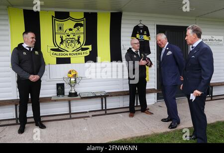 The Prince of Wales, along with Lord Caledon (right), in conversation with Chariman of Caledon Rovers FC Kevin O'Connor and Graeme Parr, trustee, (left), during his visit to Caledon where he viewed the sites of upcoming development projects around the village. Picture date: Wednesday May 19, 2021. Stock Photo