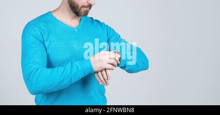 cropped guy checking time. guy with wristwatch. copy space. cropped man in casual wear accessory. Stock Photo
