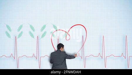 Composition of businessman drawing heart on heart rate processor reading Stock Photo