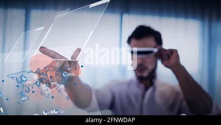 Composition of man wearing vr headset touching interactive screen with data processing Stock Photo