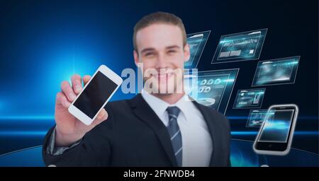 Composition of smiling businessman showing smartphone over digital screens with data processing Stock Photo