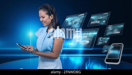 Composition of smiling businesswoman using smartphone over digital screens with data processing Stock Photo