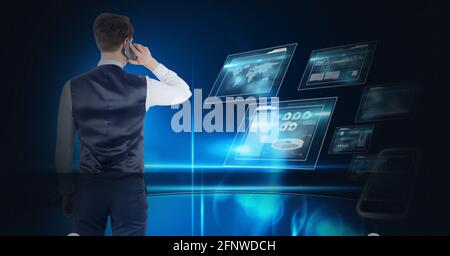 Composition of businessman talking on smartphone over digital screens with data processing Stock Photo