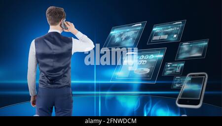 Composition of businessman talking on smartphone over digital screens with data processing Stock Photo