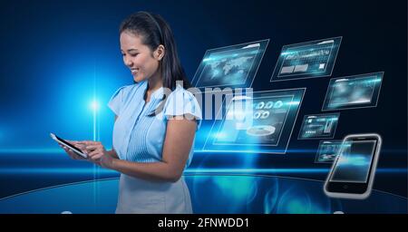 Composition of smiling businesswoman using smartphone over digital screens with data processing Stock Photo